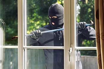 image of burglar entering a window